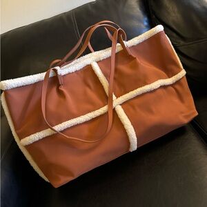 Camel and fuzzy white weekender bag